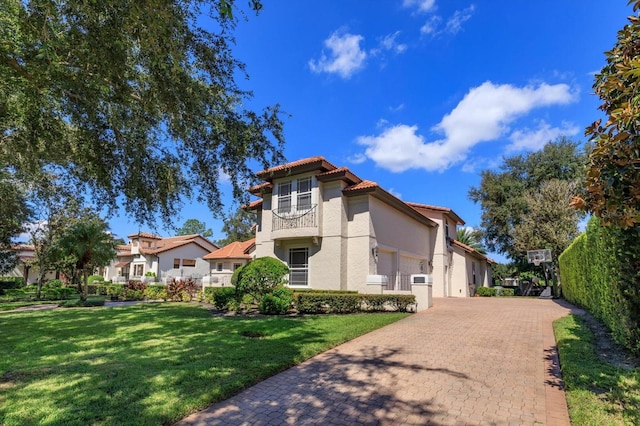 mediterranean / spanish home with a front lawn