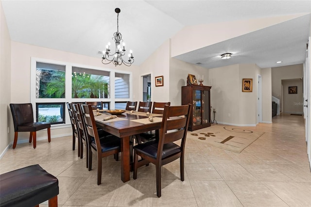 tiled dining area featuring vaulted ceiling and an inviting chandelier