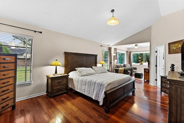 bedroom featuring multiple windows, dark wood-type flooring, and lofted ceiling