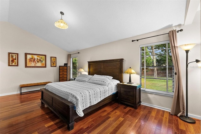 bedroom with dark wood-type flooring and lofted ceiling