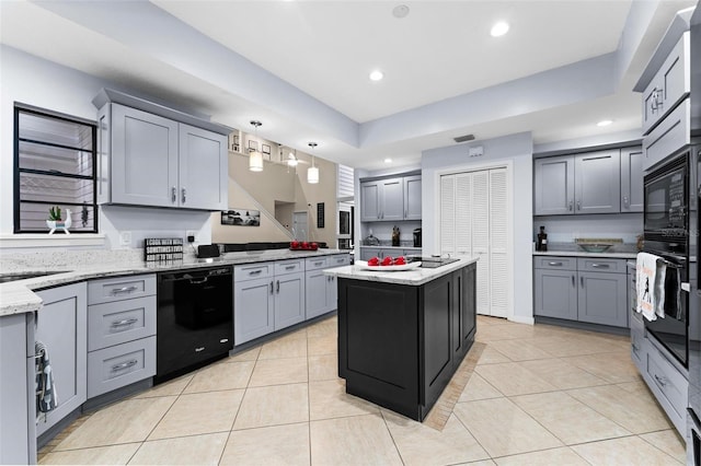 kitchen featuring light tile patterned flooring, black appliances, gray cabinets, and a kitchen island