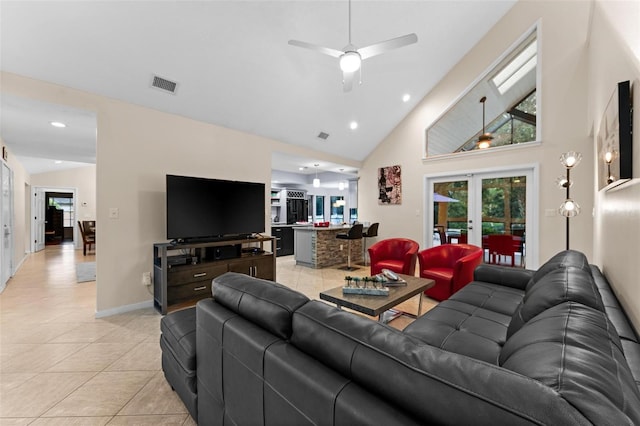 tiled living room with french doors, high vaulted ceiling, and ceiling fan