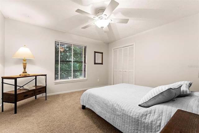 carpeted bedroom with a closet and ceiling fan