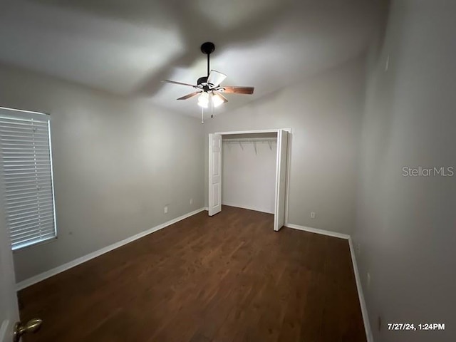 unfurnished bedroom featuring dark wood-type flooring and ceiling fan