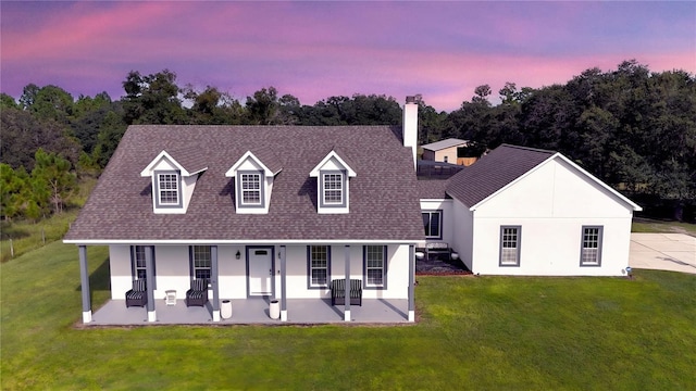 exterior space with covered porch and a lawn