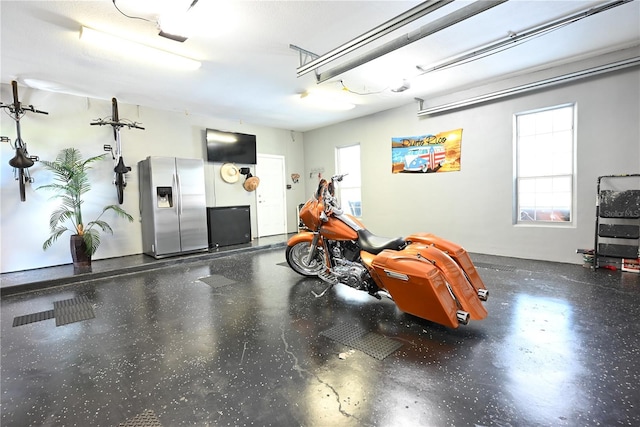 garage with stainless steel fridge