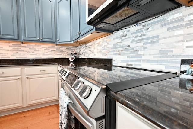 kitchen with blue cabinetry, tasteful backsplash, light wood-type flooring, and white cabinets