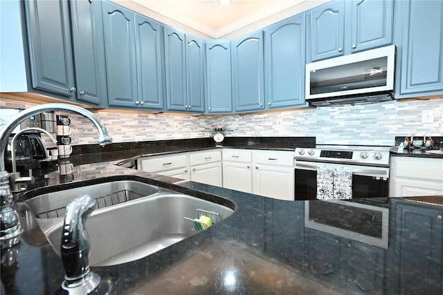 kitchen with appliances with stainless steel finishes, blue cabinets, and sink