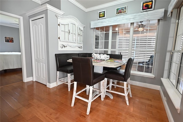 dining area featuring ornamental molding, wood-type flooring, and ceiling fan