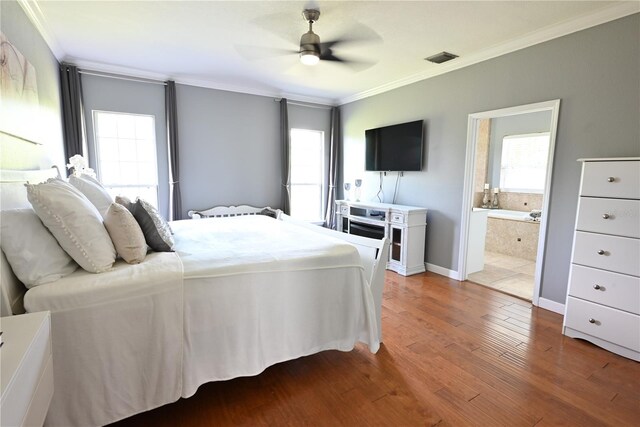 bedroom featuring ensuite bath, multiple windows, and ceiling fan