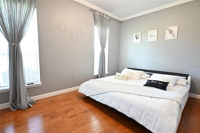 bedroom with crown molding and wood-type flooring