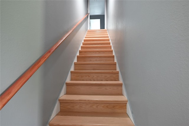 stairs featuring hardwood / wood-style flooring