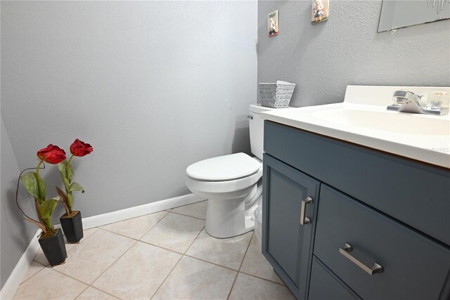 bathroom featuring vanity, toilet, and tile patterned floors