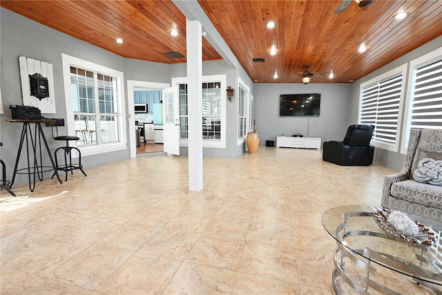 living room with wood ceiling and ceiling fan