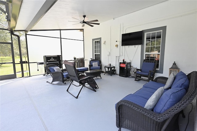 view of patio / terrace with ceiling fan and a lanai