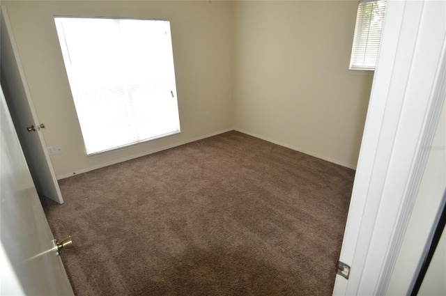 empty room with dark colored carpet