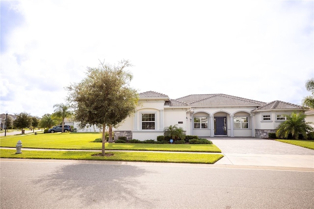 mediterranean / spanish-style house featuring a front yard