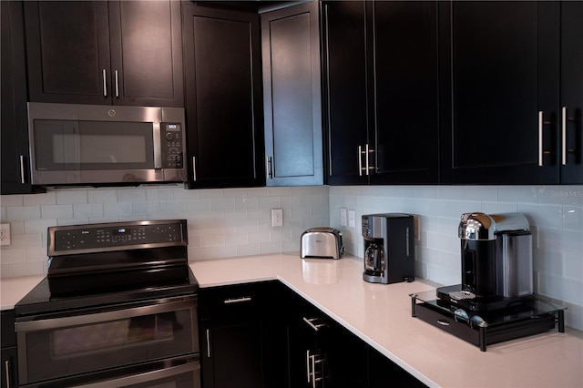 kitchen with backsplash and appliances with stainless steel finishes