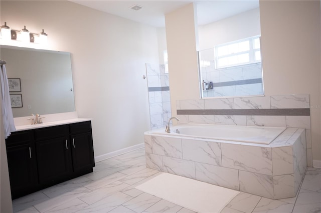 bathroom featuring vanity and separate shower and tub