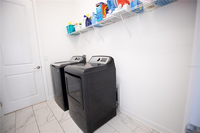 clothes washing area featuring independent washer and dryer