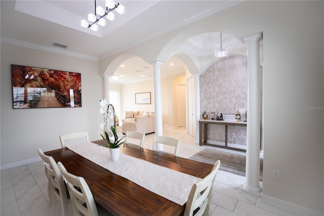 dining area with ornate columns, a notable chandelier, and ornamental molding