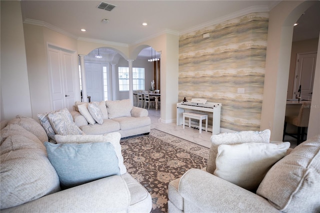 living room featuring decorative columns and crown molding