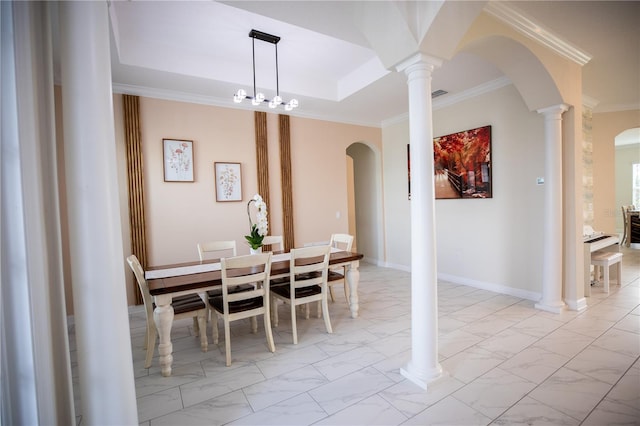 dining area featuring a chandelier, decorative columns, and crown molding