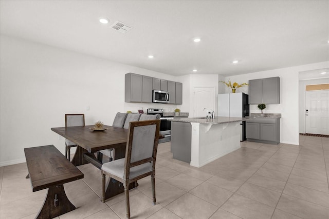 dining area featuring light tile patterned floors and sink