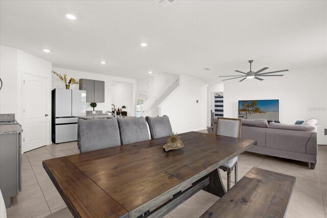 dining space featuring ceiling fan, light tile patterned flooring, and sink