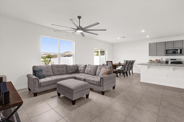 living room featuring light tile patterned floors and ceiling fan