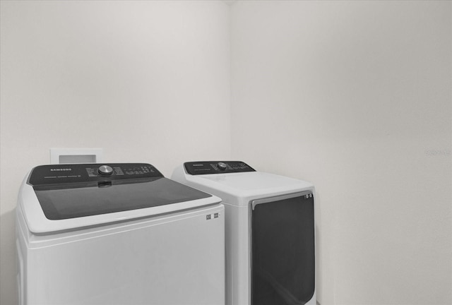 clothes washing area featuring washer and dryer