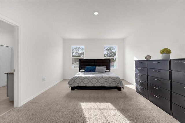 bedroom featuring light colored carpet