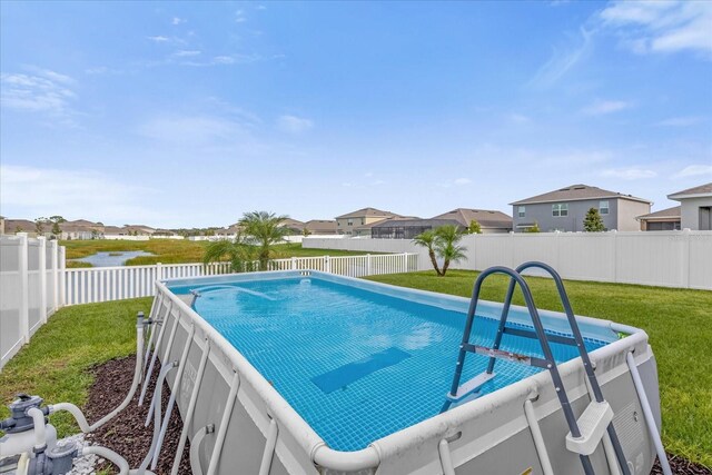 view of pool featuring a lawn and a water view