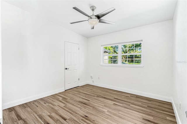 empty room featuring lofted ceiling, ceiling fan, and light hardwood / wood-style floors