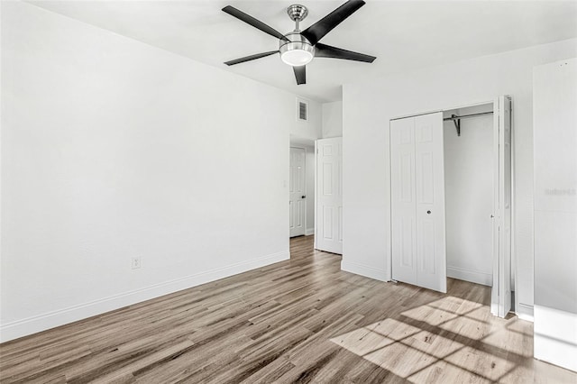 unfurnished bedroom with ceiling fan, light hardwood / wood-style floors, and a closet