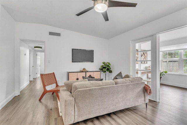 living room with ceiling fan and light hardwood / wood-style flooring