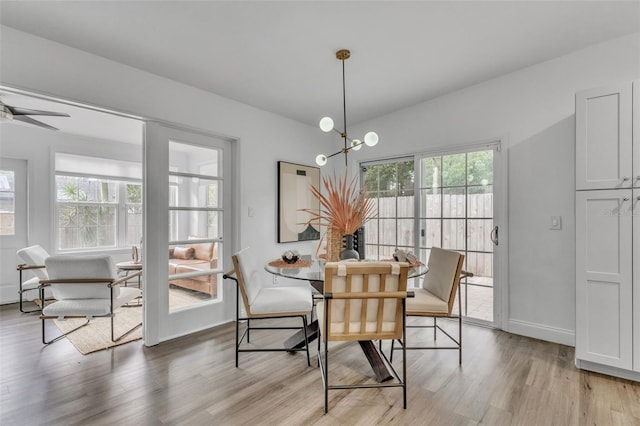 dining room with light wood-type flooring and ceiling fan