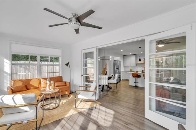 living room with ceiling fan and hardwood / wood-style floors