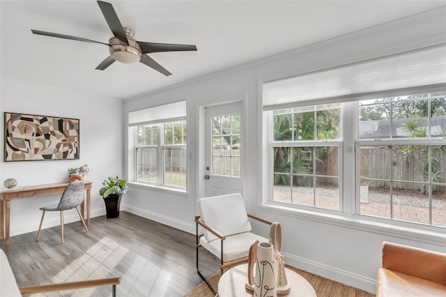 sunroom featuring ceiling fan and plenty of natural light