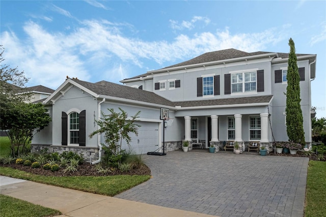 view of front of home featuring a garage and a porch