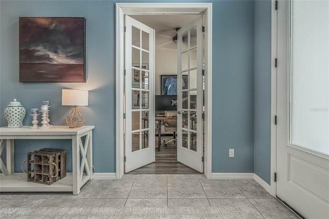 doorway with light tile patterned floors and french doors