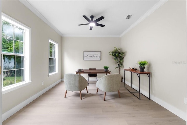 office area with light wood finished floors, baseboards, crown molding, and a ceiling fan