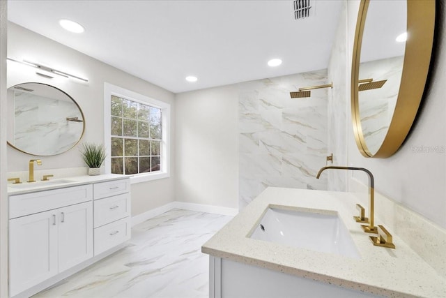 bathroom with a tile shower and vanity