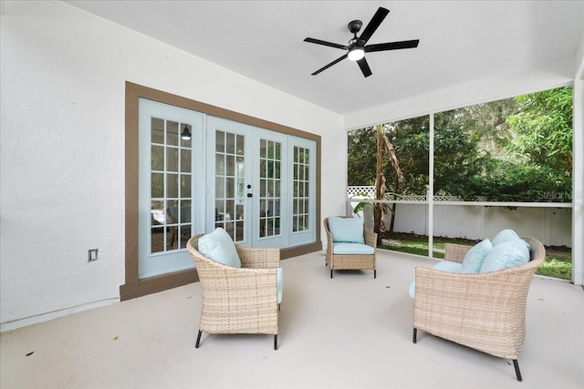 sunroom / solarium with french doors and a ceiling fan