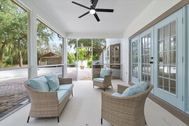 sunroom featuring an outdoor living space, french doors, and a ceiling fan