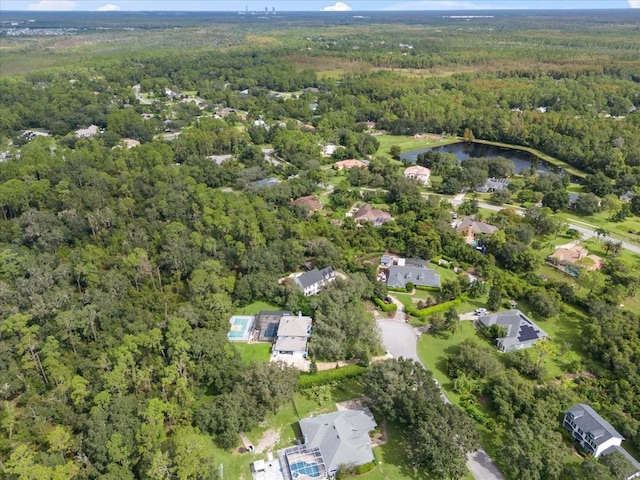 drone / aerial view featuring a water view and a view of trees