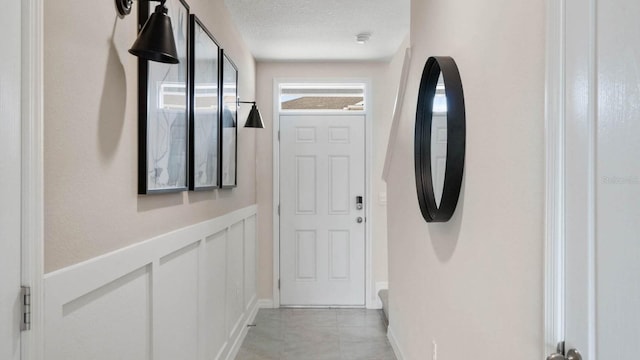 hall featuring a textured ceiling