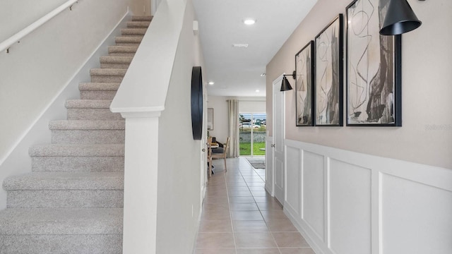 staircase with tile patterned floors