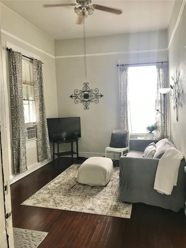 living room featuring ceiling fan and dark hardwood / wood-style floors