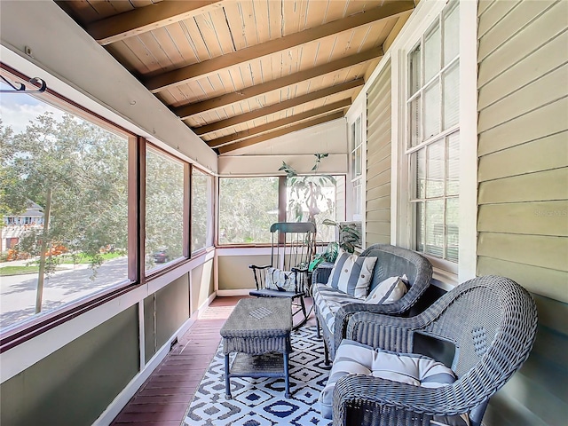 sunroom / solarium featuring lofted ceiling with beams, plenty of natural light, and wooden ceiling